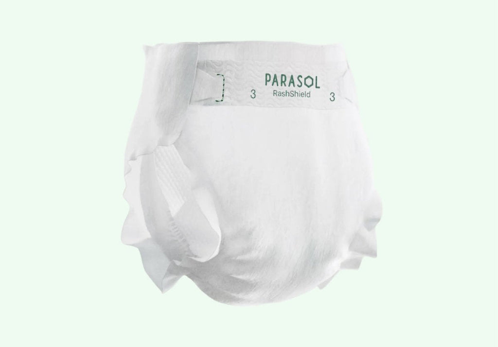 Unprinted white Parasol RashShield Size 3 diaper shown from the side with the Parasol logo on the tab