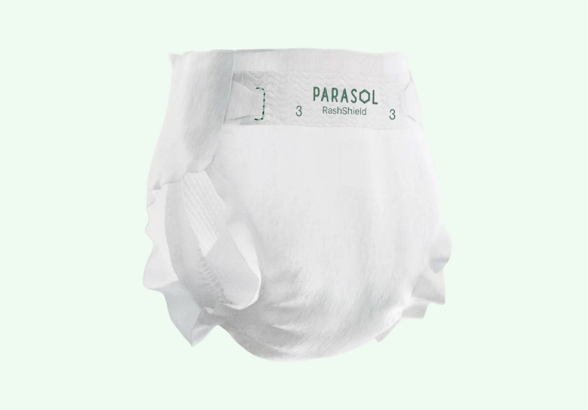 Unprinted white Parasol RashShield Size 3 diaper shown from the side with the Parasol logo on the tab