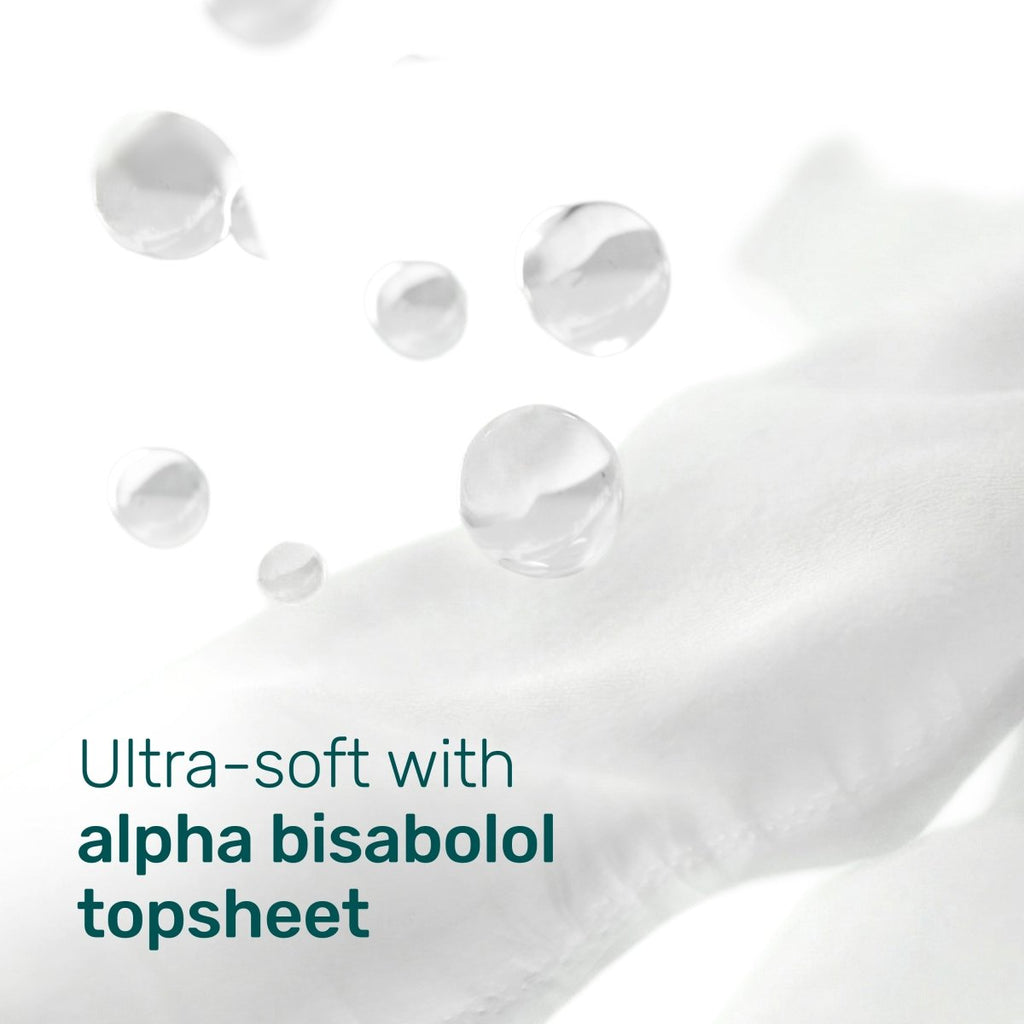 Soft white diaper topsheet fabric with water droplets and the text “Ultra-soft with alpha bisabolol topsheet”