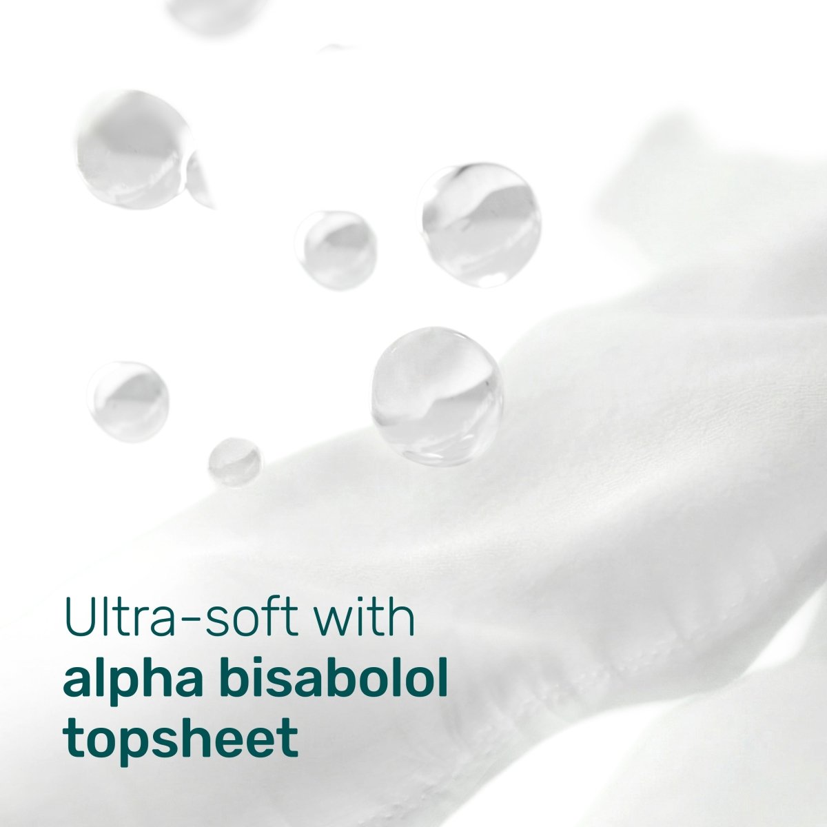 Soft white diaper topsheet fabric with water droplets and the text “Ultra-soft with alpha bisabolol topsheet”