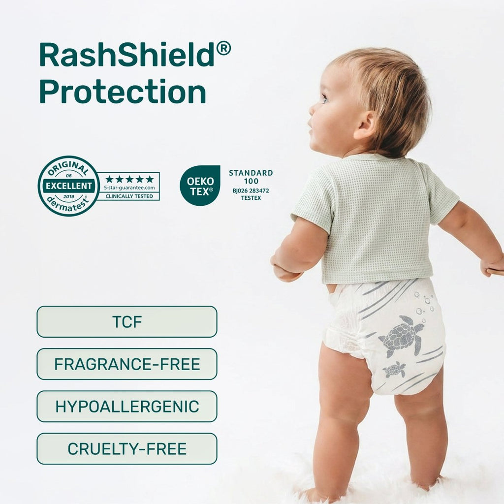 Toddler in a white Parasol diaper with a gray sea turtle print, beside RashShield Protection badges: Dermatest Excellent, OEKO-TEX Standard 100, TCF, fragrance-free, hypoallergenic, cruelty-free