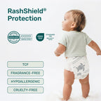 Toddler in a white Parasol diaper with a gray sea turtle print, beside RashShield Protection badges: Dermatest Excellent, OEKO-TEX Standard 100, TCF, fragrance-free, hypoallergenic, cruelty-free