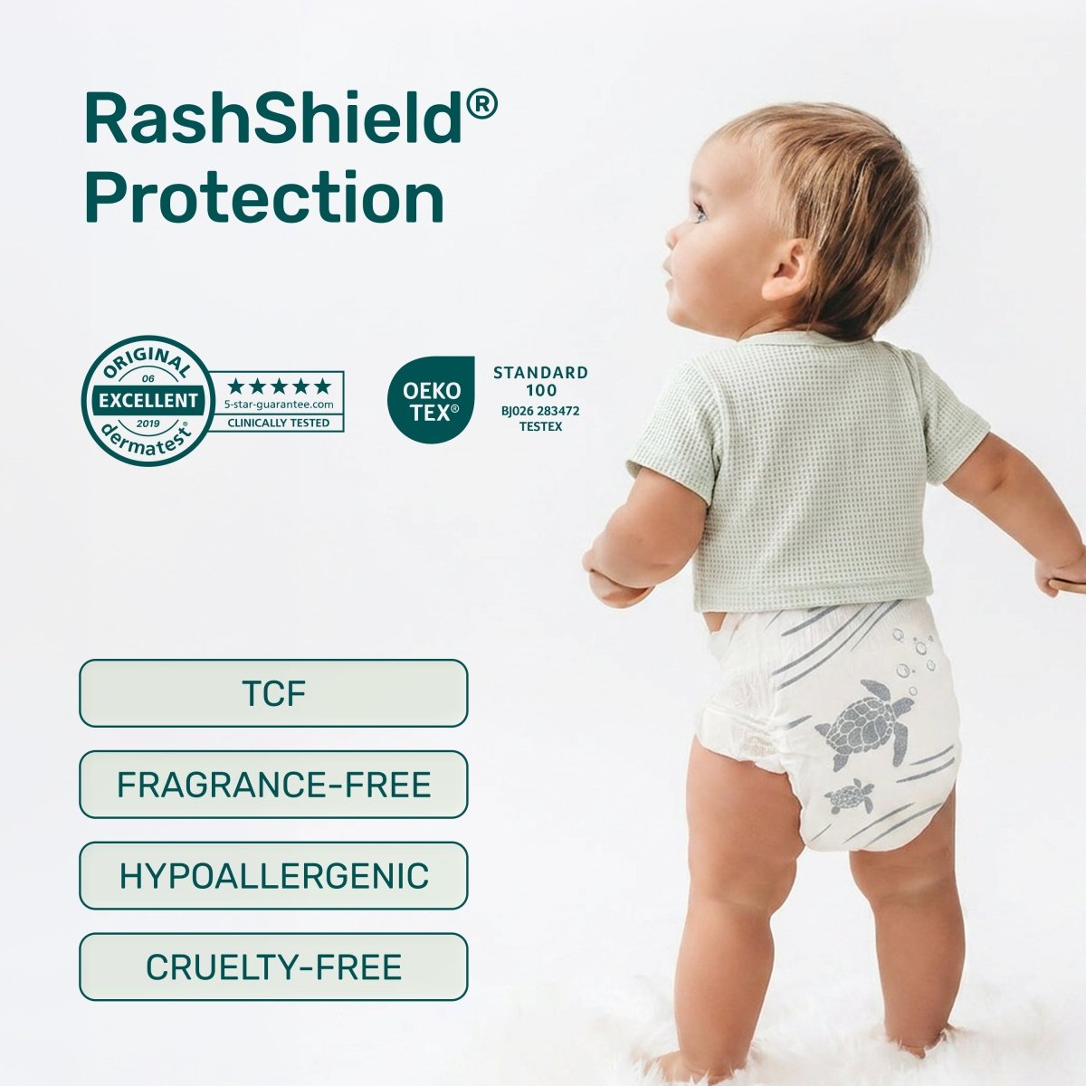 Toddler in a white Parasol diaper with a gray sea turtle print, beside RashShield Protection badges: Dermatest Excellent, OEKO-TEX Standard 100, TCF, fragrance-free, hypoallergenic, cruelty-free